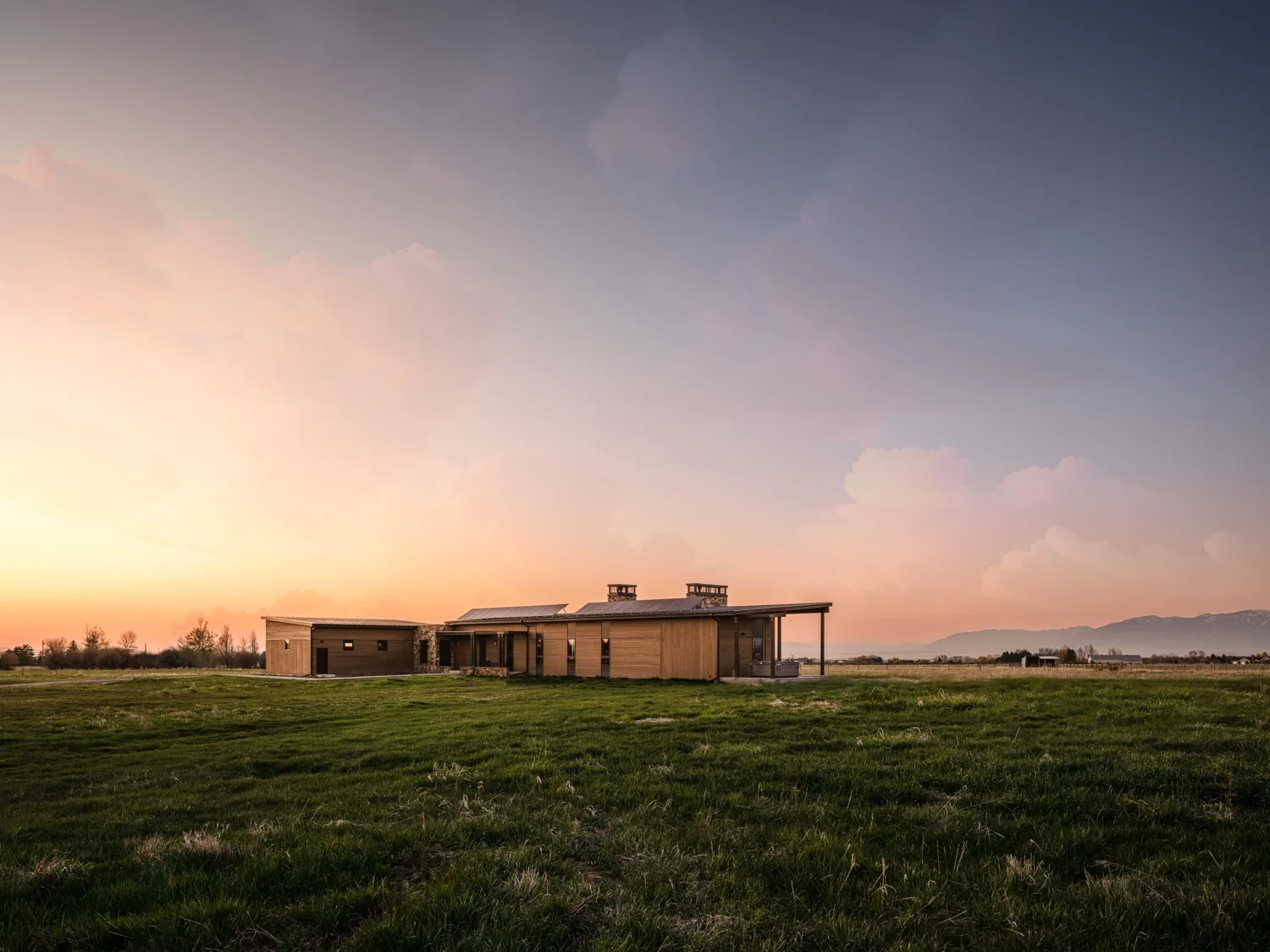 Mid-century modern home in an open field at twilight
