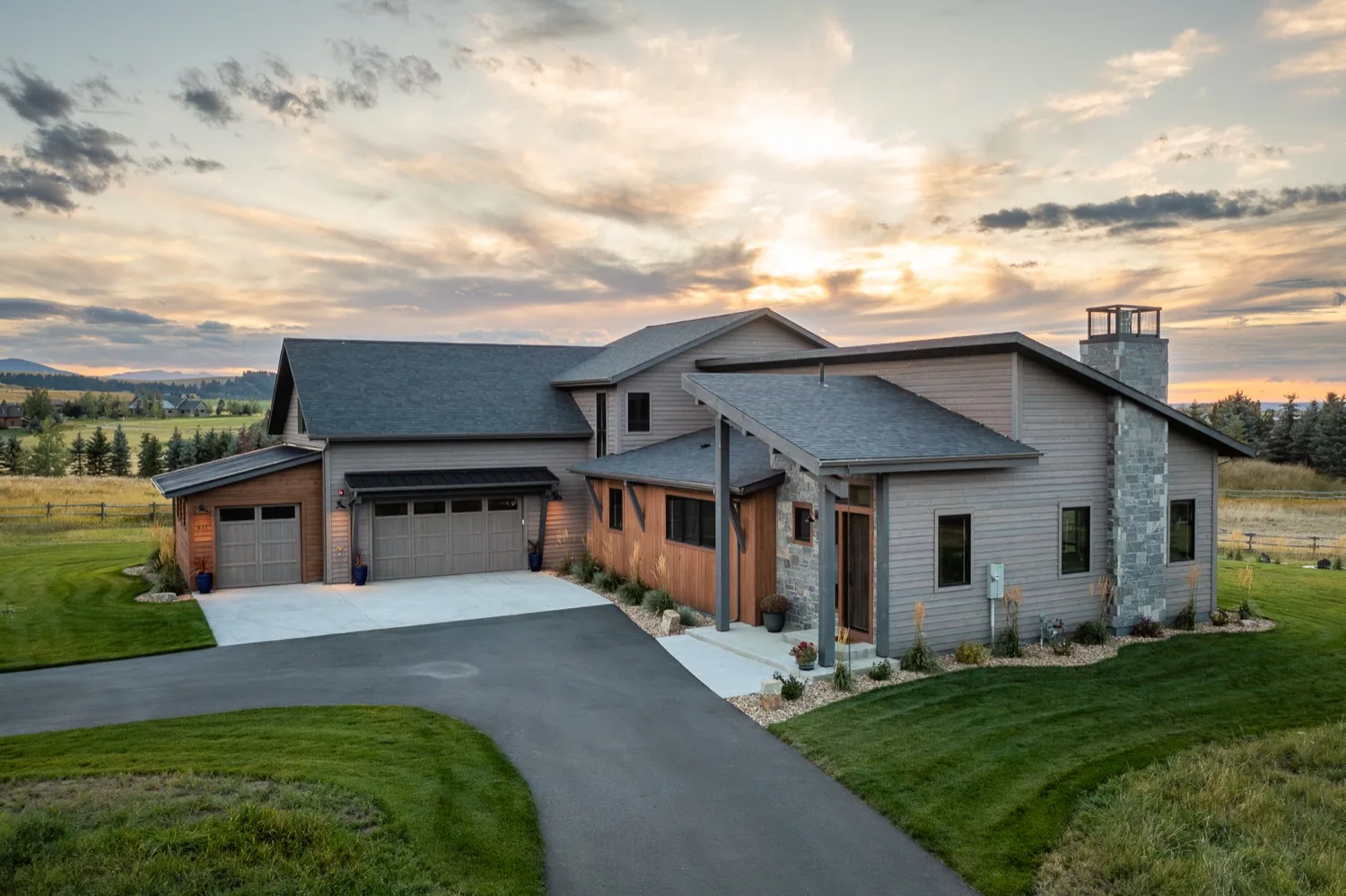 Mountain modern home with mixed siding and a stone chimney